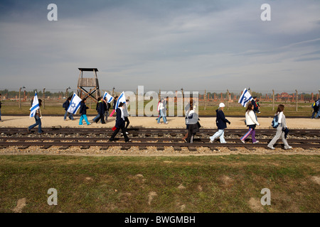 Poland Oswiecim Auschwitz  Birkenau former Nazi German WW2 Death Camp. Young visitors with State of Israel National Flag Stock Photo