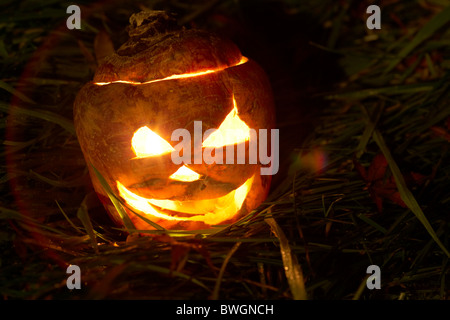 illuminated halloween turnip jack-o-lantern to ward off evil spirits. Traditionally in Ireland turnips or swedes were used Stock Photo