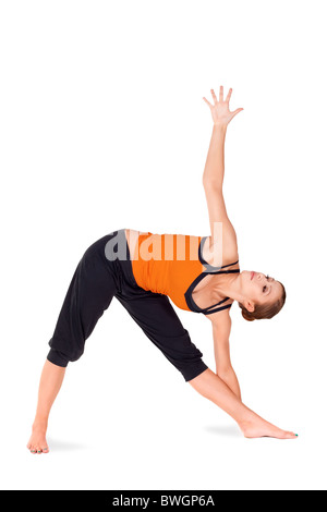 Fit attractive young woman practicing yoga exercise called Triangle Pose, Sanskrit name: Trikonasana Stock Photo
