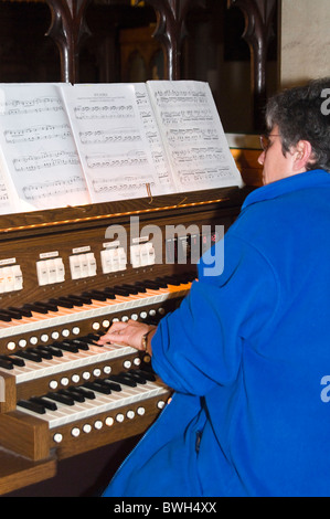 Vertical close up of an organist playing a church organ Stock Photo