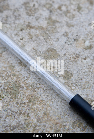 Climate Weather Station Measurement Thermometer laid on concrete to measure the minimum overnight concrete temperature Stock Photo