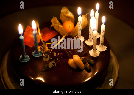 Lit happy Birthday candles on a birthday cake Stock Photo - Alamy