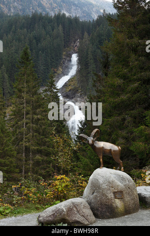 Bronze capricorn sculpture in front of the Krimmler Wasserfaelle waterfalls, Nationalpark Hohe Tauern national park, Krimml Stock Photo