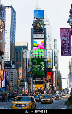 USA, New York, Manhattan, People walking in Times Square at the junction of 7th Avenue and Broadway below advertising screens Stock Photo