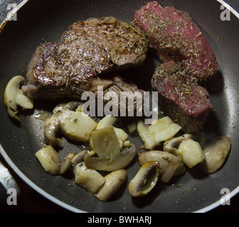 Cooking medium and rare fillet steak - 3 mins each side for medium, 1 minute each for rare, cooked together. Stock Photo