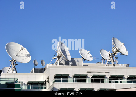 Satellite Communications Dishes on top of TV Station Stock Photo