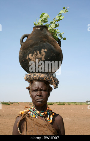 Dassanech Tribeswomen With Cooking Pot Balanced On Her Head, Omorate, Omo Valley, Ethiopia Stock Photo