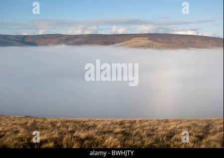 Mist above the Edale Valley in the Peak District National Park, England. Kinder Plateau rising above the cloud Stock Photo