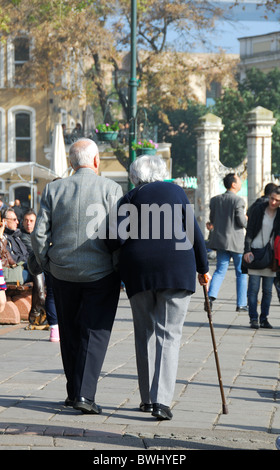 ISTANBUL, TURKEY. An elderly couple walking arm in arm in the Bosphorus suburb of Ortakoy. 2010. Stock Photo