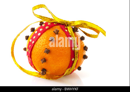 Orange with golden ribbon and cloves isolated over white Stock Photo