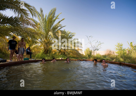 Tourist inside hot spring, Siwa Oasis, Egypt Stock Photo