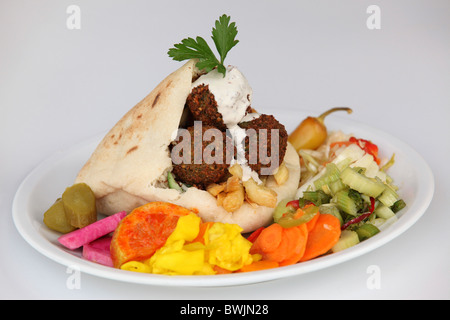 Falafel in pita bread with salad and tahini sauce and pickles Stock Photo