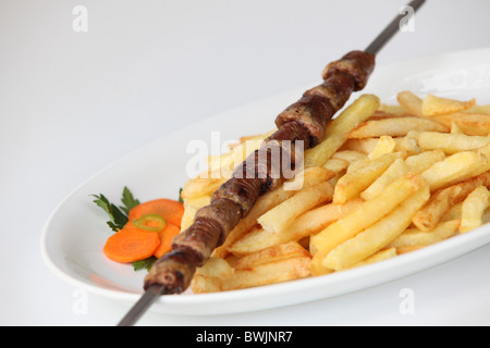 Char grilled chicken hearts Shish Kebab Skewer with french fries Stock Photo