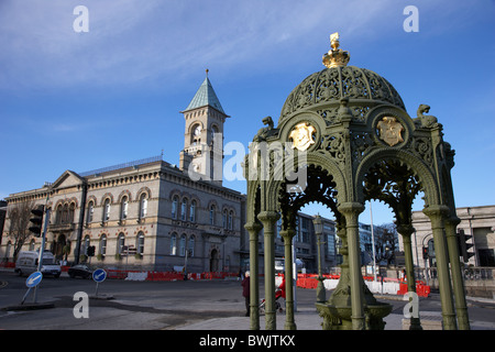 restored victorian drinking fountain with town hall in the background in dun laoghaire dublin republic of Ireland Stock Photo