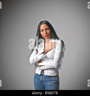 Young Hispanic woman female casual clothes, jeans, body language, arms crossed Stock Photo