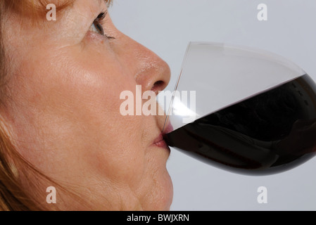 middle aged woman drinking red wine Stock Photo