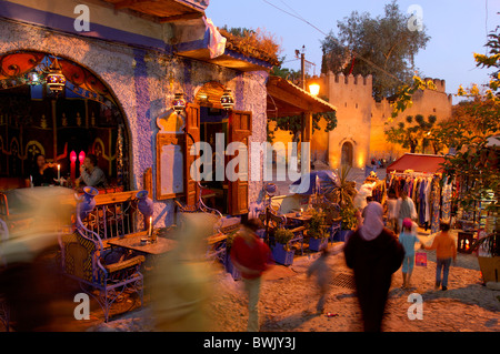 place person stand market restaurant at night night Plaza Uta el Hammam Chefchaouen Rif Mountains Morocco Africa North Africa Stock Photo
