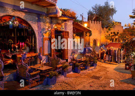 place person stand market restaurant at night night Plaza Uta el Hammam Chefchaouen Rif Mountains Morocco Africa North Africa Stock Photo