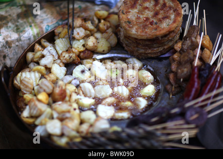 Fried potatoes and other Yunnan street food for sale in Lijiang, Yunnan Province, China. Stock Photo