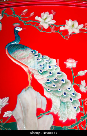 Painted jade peacock on a colourful decorative piece of Chinese furniture, Xi’an, China Stock Photo
