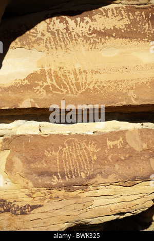 Native Maerican Indian petraglyphs on a rock face near Thermopolis in Wyoming, United States of America Stock Photo