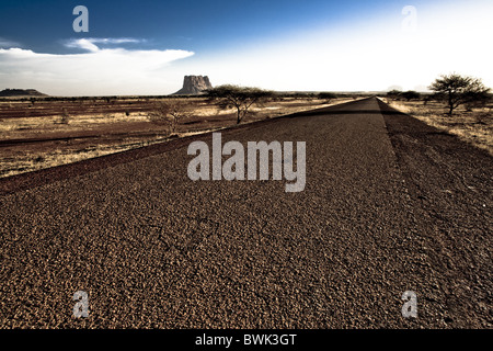 Empty country road under clouded sky, Mali, Africa Stock Photo