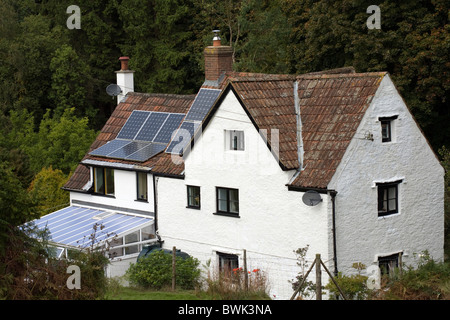 A cottage fitted with solar panels in The Forest of Dean Gloucestershire England Stock Photo