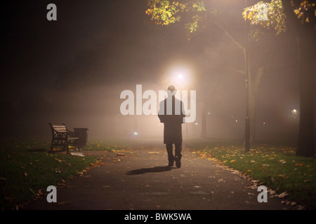 man with trench coat and hat in the park Stock Photo