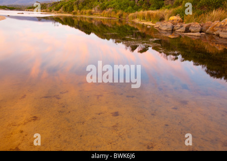 Early morning reflections in the lagoon at Lagoons Beach, Chain of Lagoons north of Bicheno on the east coast of Tasmania Stock Photo