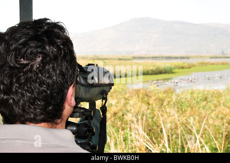 Israel, Hula Valley, Lake Agamon Bird sanctuary nature reserve Bird watcher's telescope overlooking the lake from within a hide Stock Photo