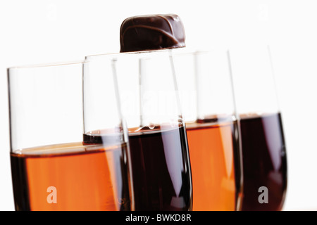 Glasses of sherry and port with a chocolate praline on top Stock Photo