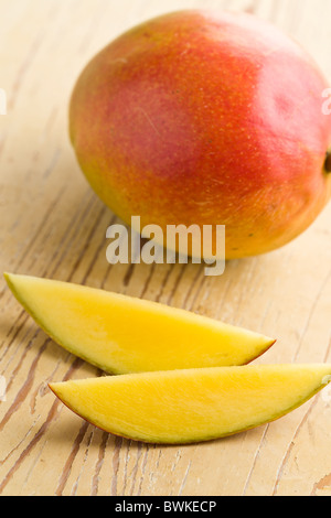 fresh mango fruit on wooden table Stock Photo