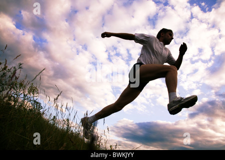 View from below of sportsman doing exercise Stock Photo