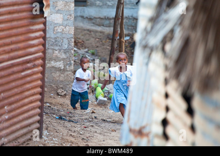 Girl running down an alley on Lamu Island, Kenya Stock Photo