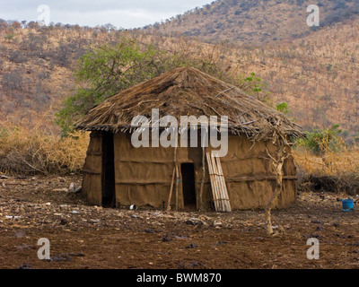 Traditional Masai mud and thatch hut in Tanzania. Stock Photo