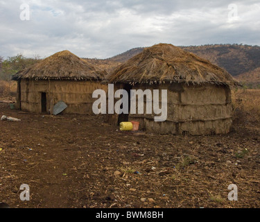 Traditional Masai mud and thatch huts in Tanzania. Stock Photo