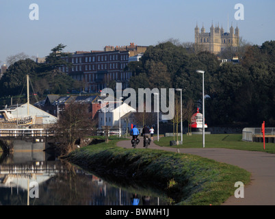 Exeter Canal with view cathedral in background Exe valley cycle route with cyclist walkers Devon UK Stock Photo