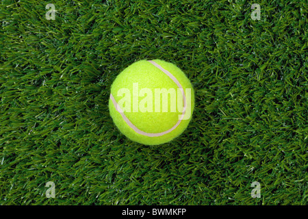 Photo of a tennis ball on grass Stock Photo