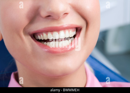 Close-up of happy female showing her healthy teeth Stock Photo