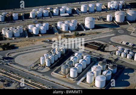 Oil tanks next to sea with railroad tracks. Stock Photo