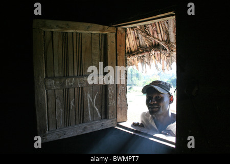 Ethiopian Man Looking Through Wooden Window Of His Hut Stock Photo