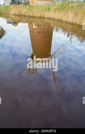 Norfolk England UK Reflection of Horsey Wind pump in the drainage ditch Stock Photo