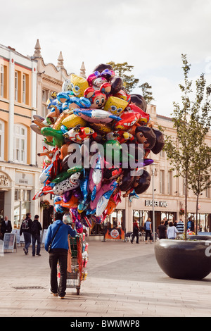 Cardiff (Caerdydd), South Glamorgan, South Wales, UK. Street vender selling helium balloons in the city centre Stock Photo