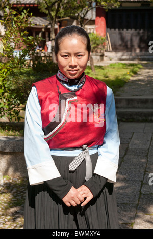 Young Naxi woman wearing traditional costume, Baisha village, near Lijiang, Yunnan Province, China Stock Photo