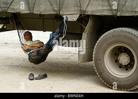 Man sleeping in hammock under his truck, Fuli, Guangxi, China Stock Photo