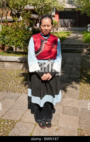 Young Naxi woman wearing traditional costume, Baisha village, near Lijiang, Yunnan Province, China Stock Photo