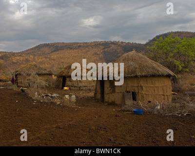 Traditional Masai mud and thatch huts in Tanzania. Stock Photo
