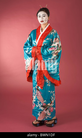 Asian female with geisha style face paint in yukata (kimono) Stock Photo