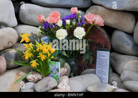 This cairn is a memorial to the dead, flowers have been placed to remember people's dead mothers on Mother's Day. DAVID MANSELL Stock Photo