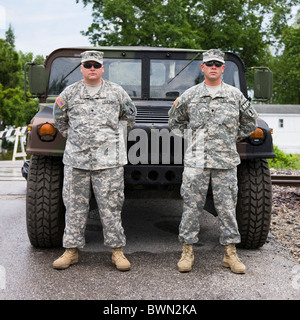 USA, Missouri, Portrait of two US soldiers standing in front of hummer Stock Photo